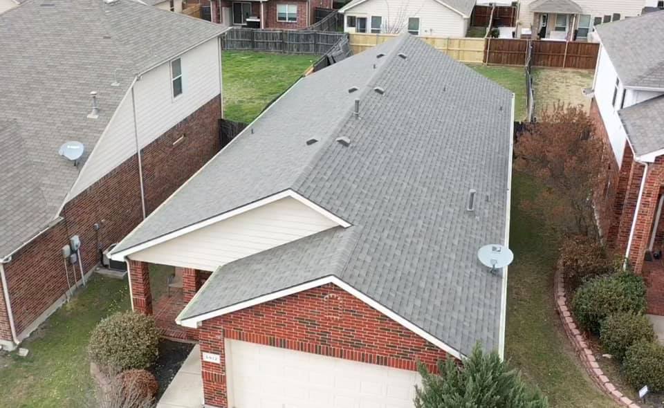 An aerial after of a roof install in Weathered Wood