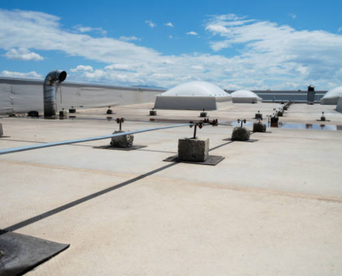 Fragment of the roof of a commercial building with an external unit of the commercial air conditioning and ventilation systems