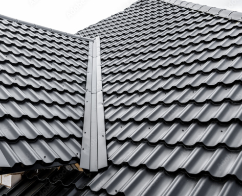 Construction of the roof of the house. Metal tiles.