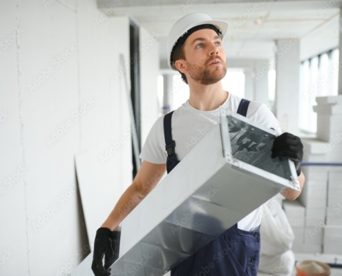 hvac services - worker install ducted pipe system for ventilation and air conditioning