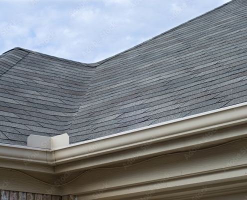 Rain Gutters Splash Guard on Roof against blue sky