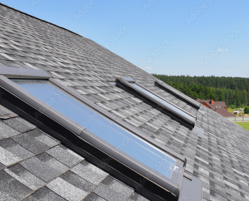 Roof windows and skylights and blue sky