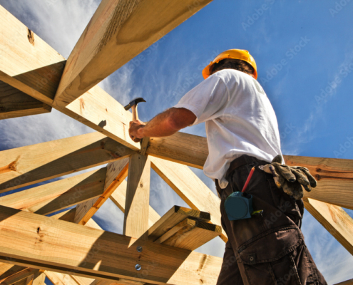 roofer ,carpenter working on roof structure at construction site