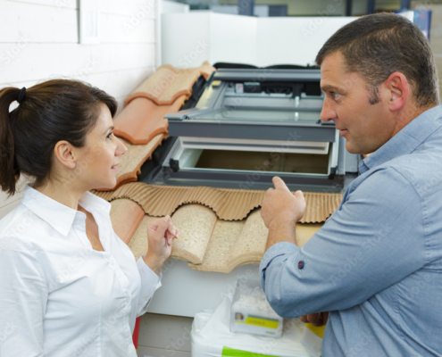 sales assistant showing roof lights to customer