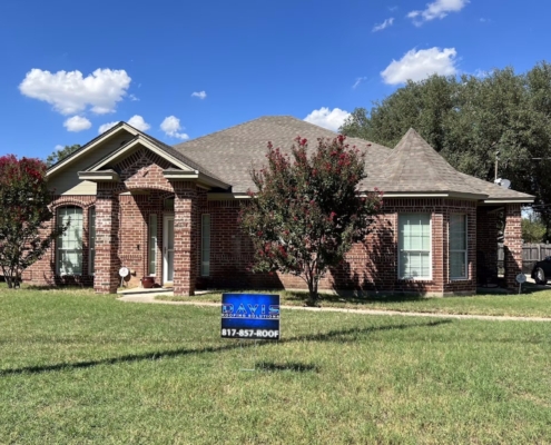 Single-story brick home with a finished brown shingle roof and a Davis Roofing yard sign out front