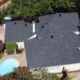 Aerial of a completed charcoal shingle roof overlooking a backyard pool