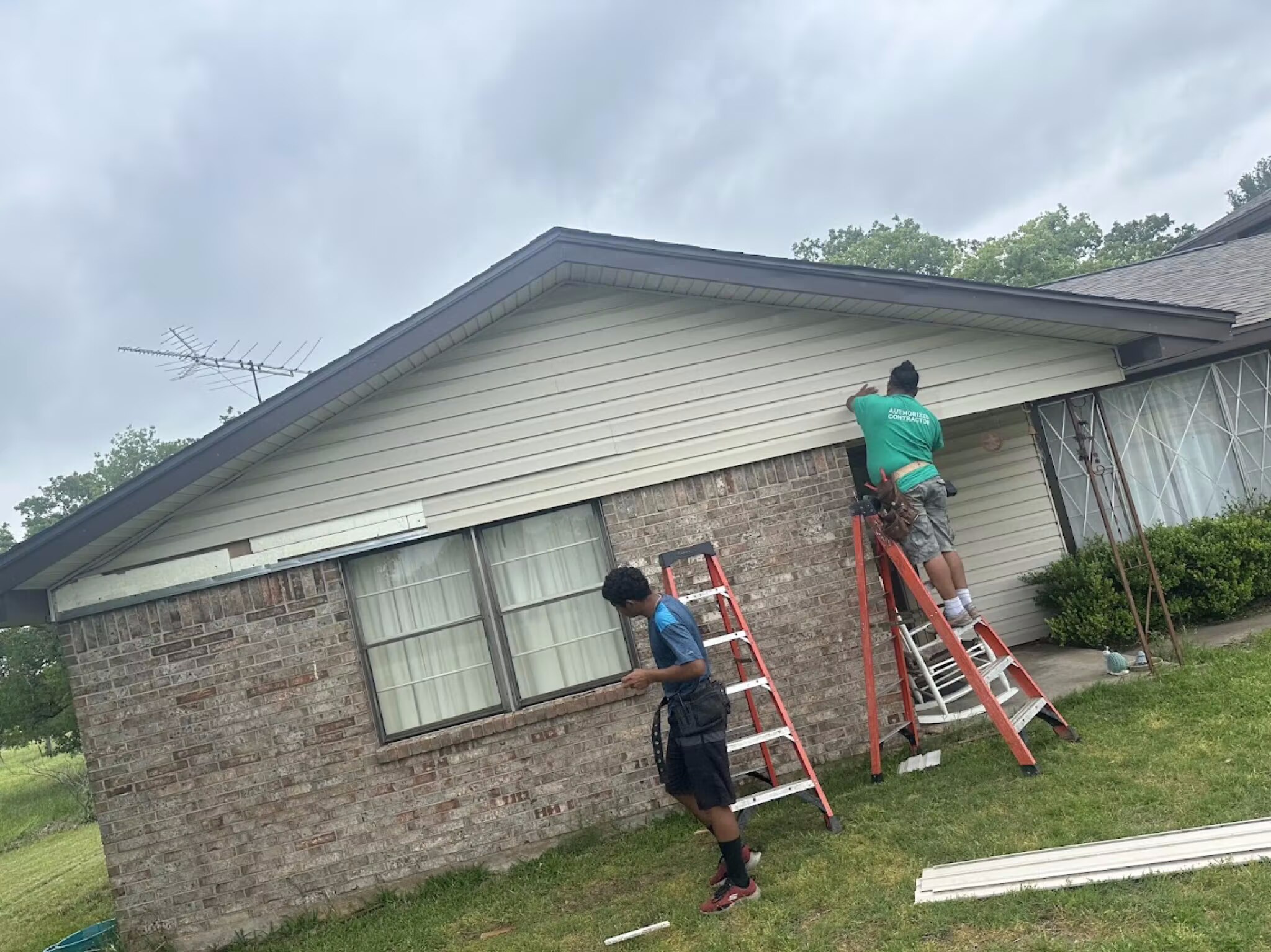 Davis Roofing Solutions crew repairing fascia and soffit on a DFW ranch home