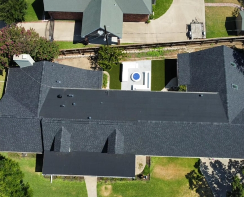 Overhead drone view of a home's new charcoal shingle roof
