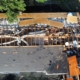 Overhead view of a roof torn down to the rafters and framing during a major rebuild